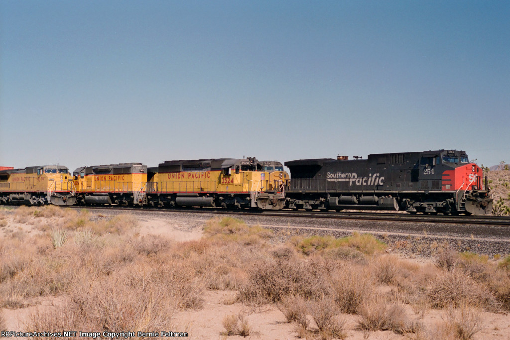 Southern Pacific AC44CW #254 is stopped next to two other sets of power 